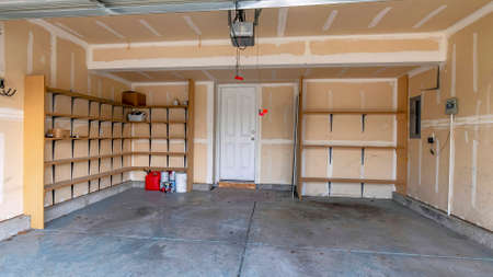 Panorama Interior of garage with a white line markings, wooden shelves and white doorの写真素材