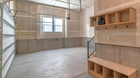 Panorama Unfinished garage door interior with mudroom and windowsの写真素材