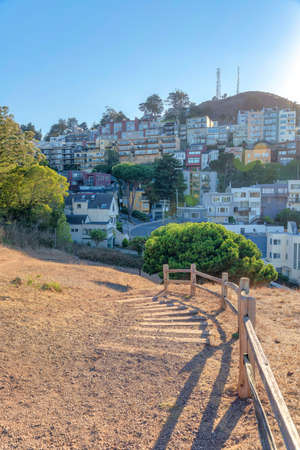 Trail on a hiking park in San Francisco, California with wooden barriers near the slopeの写真素材