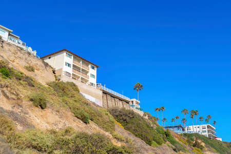 Slope with shrubs and palm trees near the neighborhood in San Clemente, Californiaの写真素材