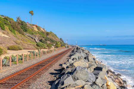 Train track near the beach at San Clemente, California with rock seawallの写真素材
