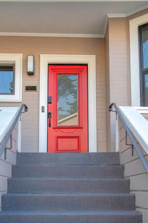 Red front door with window panel and digital key lock at San Francisco, Californiaの写真素材
