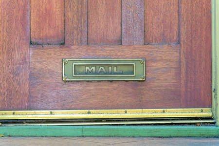 Letterbox on a wooden door at San Francisco, Californiaの写真素材