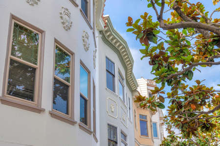 Complex residential buildings with ornate trims in a low angle view at San Francisco, Californiaの写真素材