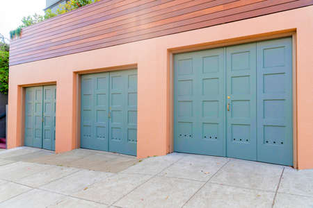 Three side-hinged garage doors with gold door handles at San Francisco, Californiaの写真素材