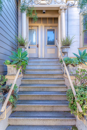 Staircase with plants near the railing at the entrance of a house in San Francisco, Californiaの写真素材
