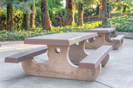 Picnic table with two seats on a concrete pavement at Japanese Friends Garden in San Jose, CAの写真素材