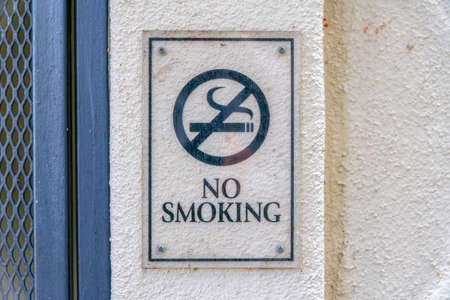 Acrylic no smoking signage against the beige wall in Silicon Valley, San Jose, California