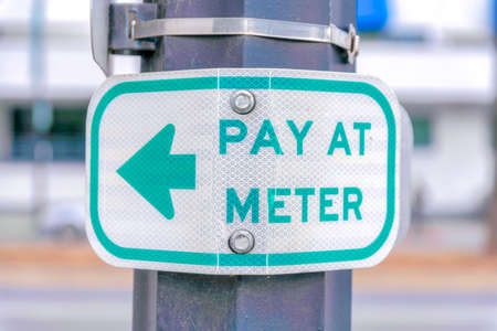 Pay at meter sign on a post at Silicon Valley, San Jose, California
