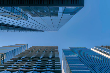 Buildings exterior in Austin Texas viewed from the street against blue sky. Looking up at modern skyscrapers with windows at the facade reflecting the cityscape views.の写真素材