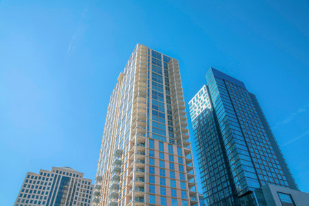 Looking up at building exterior at a residential complex in Austin Texas. Modern city skyline with...