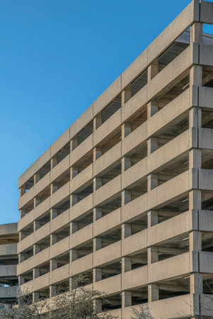 Parking garage building exterior at San Antonio, Texas. Multi-storey parking garage against the view of clear blue sky background.の写真素材