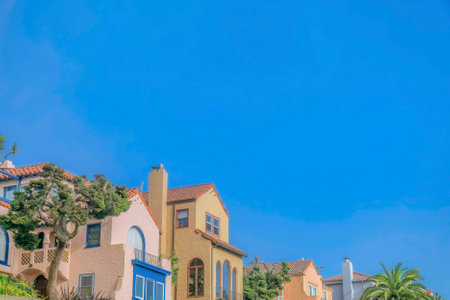 Colorful houses exterior with cloudless blue sky background on a sunny day. Scenic residential landscape at a quiet neighborhood in San Francisco California.の写真素材