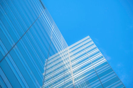 Austin, Texas- Low angle view of a building with reflective glass exterior. Glass building exterior...