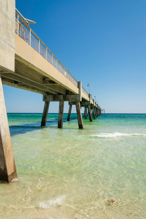 Okaloosa Island Pier view over the calm ocean at Destin, Florida. Underneath the pier view from below with a clear sky background.の写真素材