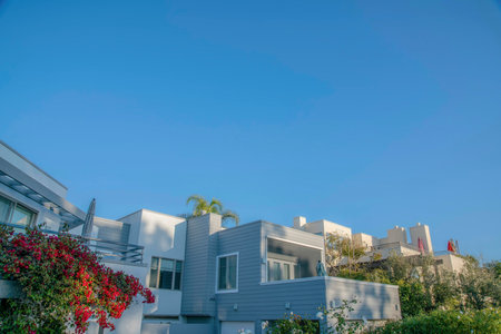 Houses with gray and white exterior wall against blue sky at Del Mar California. Facade of upscale homes at a seaside community neighborhood viewed on a beautiful day.の写真素材