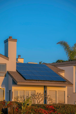 House with solar panels on roof at Del Mar Southern California against blue sky. Exterior view of a beach home with renewable green energy source at a seaside neighborhood.の写真素材