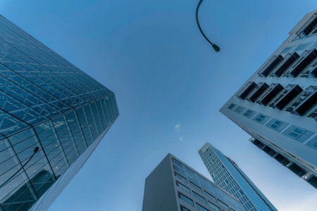 Looking up at modern houses buildings and street light pole against blue sky. Exterior view of apartments, flats or offices with glass windows and balconies at the facade in Austin Texas.の写真素材