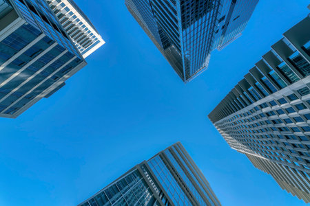 Looking up at skyscrapers in Austin Texas skyline with blue sky background. Architectural views of towering modern buildings against clear skyscape on a sunny day.の写真素材