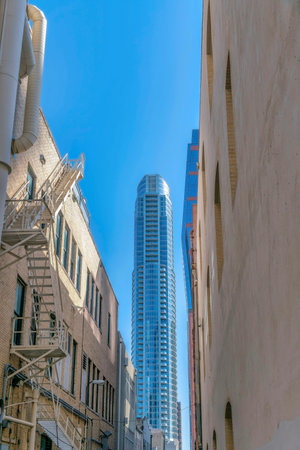 Modern apartment buildings and skyscrapers against blue sky on a sunny day. View from the back of...