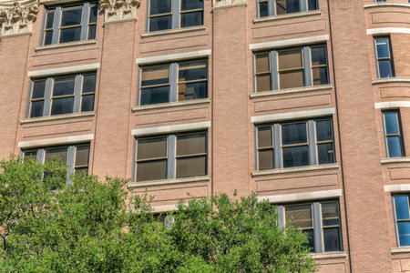 Exterior view of modern apartments with brick wall and sliding sash window. Real estate property in...