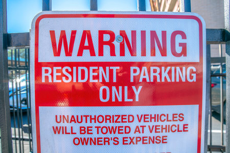 Warning resident parking only signage at downtown Tucson, Arizona. Close-up of a red warning signage...