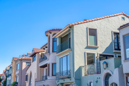 Row of painted mediterranean houses in San Francisco, CA. Exterior of houses with railings and picture windows with reflective glass panes.の写真素材