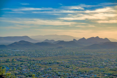 Residential area at Tucscon, Arizona near the mountain ranges against the sunset sky background. View of a wide land area from above.の写真素材