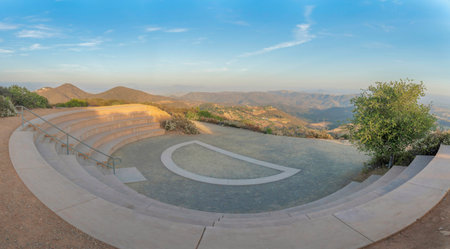 Small half amphitheatre near the edge of a mountain slope in San Diego, California. Community outdoor theatre with a view of mountains and sky.の写真素材