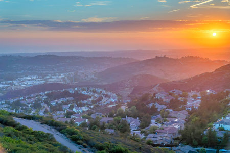 Aerial view of San Diego community against the sunset sky horizon. Whole view of a residential area surrounded by mountains at Southern California.の写真素材