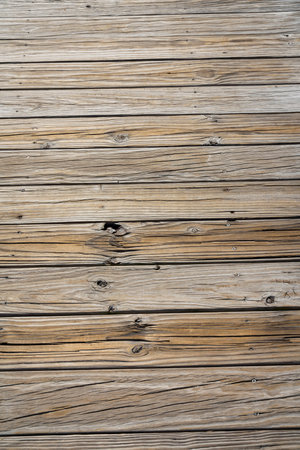 Destin, Florida- Horizontal rough wood planks flooring. Close-up view of a wooden timber planks horizontally aligned flooring from above.の写真素材