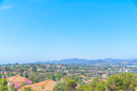High angle view of San Marcos neighborhood near the mountain at San Diego, California. There are houses in the middle with a view of the mountains at the back against the sky.の写真素材
