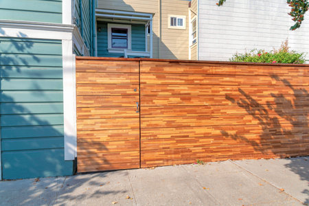 Residential building with wooden gate and fence at San Francisco, California. Wooden gate and fence...