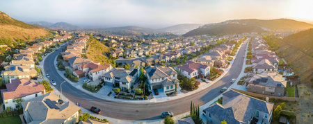 Villas in a upper middle class neighborhood around Double Peak in San Marcos, California. Aerial view of large residential buildings and curved concrete road.の写真素材