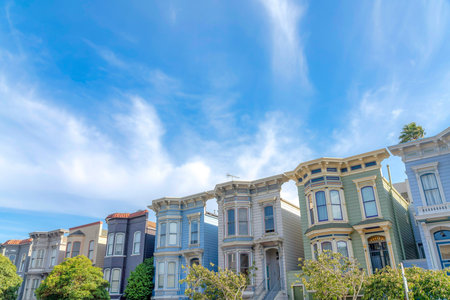 Townhouses with colorful wood vinyl sidings against the sky in San Francisco, California. Facade of...