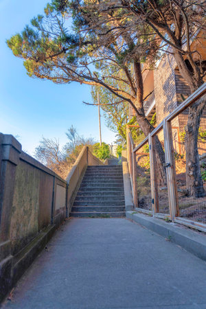 Pathway leading to a stairs outside the fence of a building in San Francisco, California. Concrete...