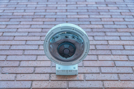View of wall-mounted panoramic cctv camera from below in San Francisco, California. Close-up of...