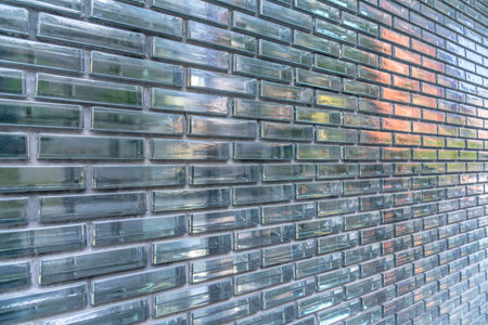 Reflective optical glass brick walls at Austin, Texas. Exterior of a building with glass brick walls with a reflections in a running bond pattern.の写真素材