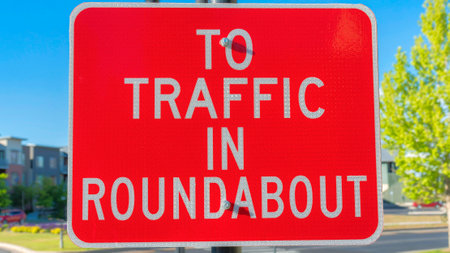 Panorama Red roadsign with white To traffic in roundabout at Daybreak in South Jordan, Utah....