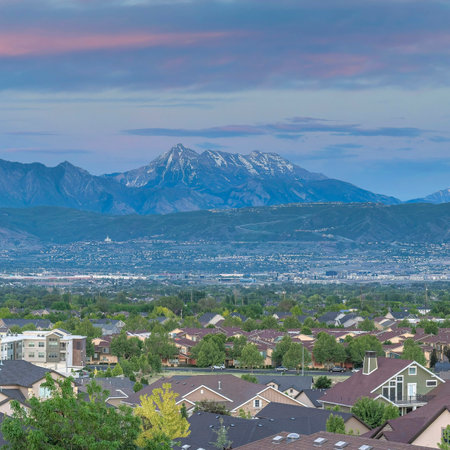 Square Dramatic sunset with clouds Panoramic view of Salt Lake City residential area in Utah. Top view of residential buildings and trees against the breathtaking mountain view and dawn sky at the background.の写真素材