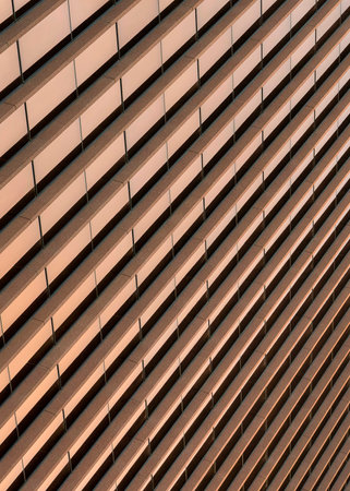 Vertical Building exterior with bronze reflective glass screen at Salt Lake City in Utah. Low angle view of a building with brown concrete wall claddings.の写真素材