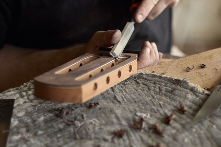 luthier modifies the head of a classical guitar.の写真素材