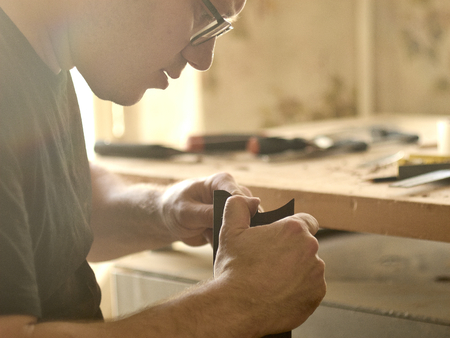 luthier polishes the body of a classical guitar.の写真素材