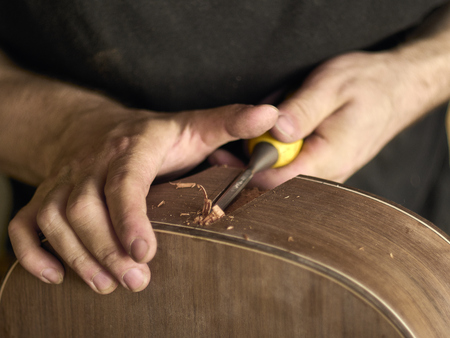 Luthier makes a neck block on a classical guitar.の写真素材