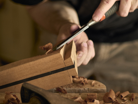 Luthier makes a neck block on a classical guitar.の写真素材