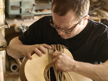 The process of making a cutaway on a classical guitar.の写真素材