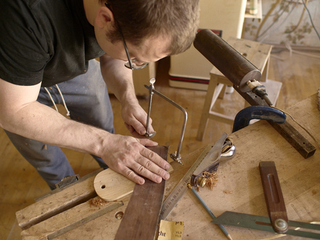 The process of making a cutaway on a classical guitar.の写真素材
