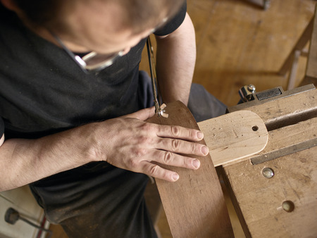 The process of making a cutaway on a classical guitar.の写真素材