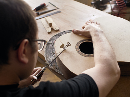 The process of making a cutaway on a classical guitar.の写真素材