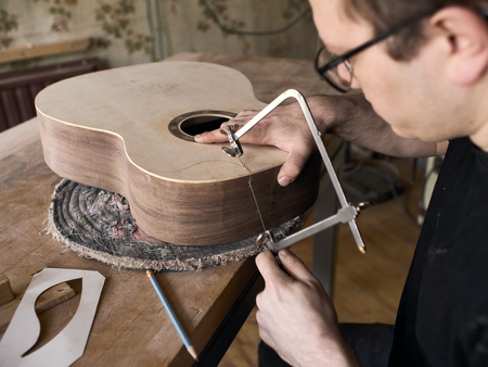 The process of making a cutaway on a classical guitar.の写真素材
